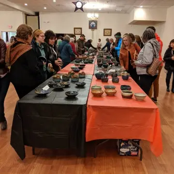 Ticket holders selecting artisan bowls during our Potter's Bowl event
