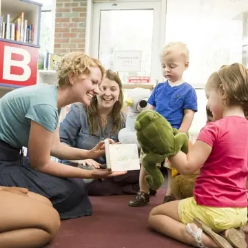 Kids playing and reading with librarians at storytime