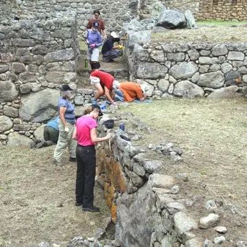 Cleaning historic buildings at Machu Picchu