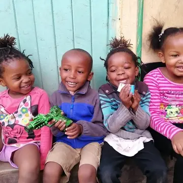 Happy children laughing outside smile community centre