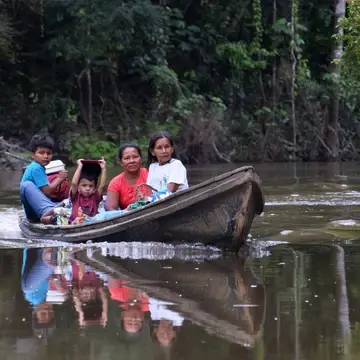 Bora family in motor canoe on Ampiyacu River