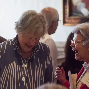 two older women patrons laughing at the Folger's Tea Party