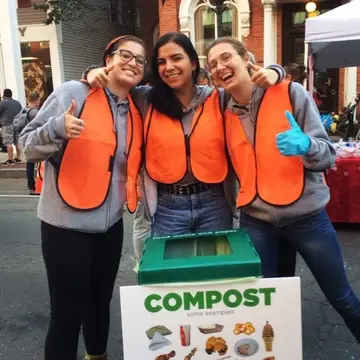 Waste experts assist with compost at an event