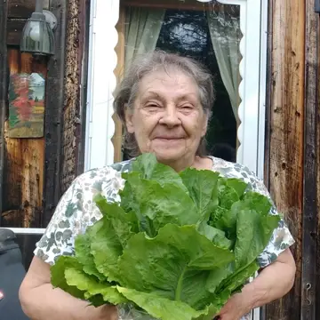 Janice holding large head of lettuce