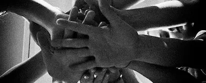 A group of hands in a huddle.