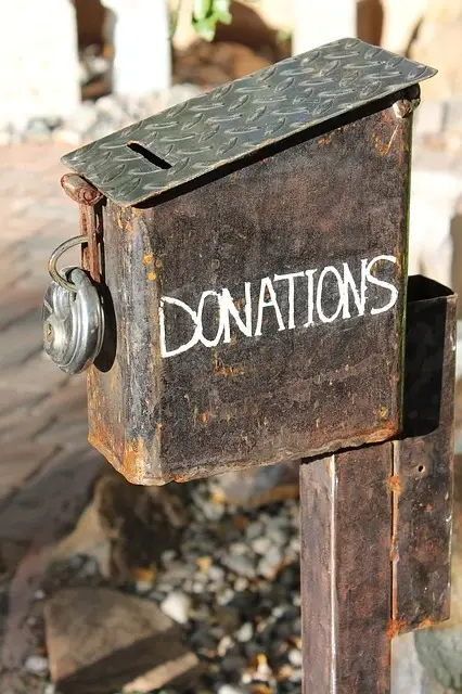 A locked metal box labeled Donations