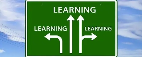 A road sign pointing to different directions. They all say Learning.