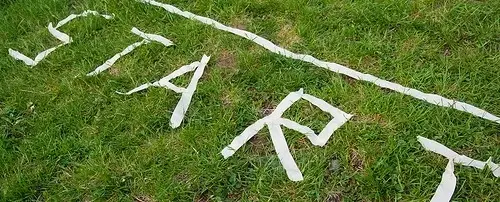The word start spelled out in tape on the grass.