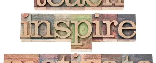 Letter blocks spelling out 'Inspire'.