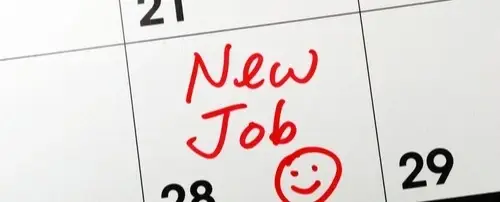 A calendar with a drawn smiley face and 'New Job' on a date.