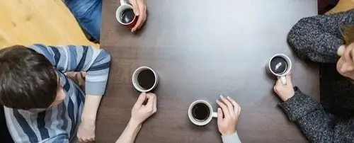A group of people having coffee together.