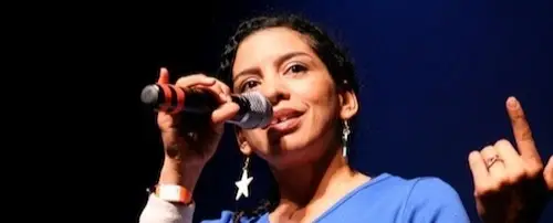 Ana “Rokafella” Garcia with a microphone in her hand.