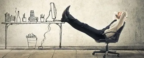 A person relaxing on a chair. His feet are propped up an illustration of a work desk.
