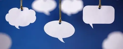 Cut-out of speech bubbles hanging by a rope.