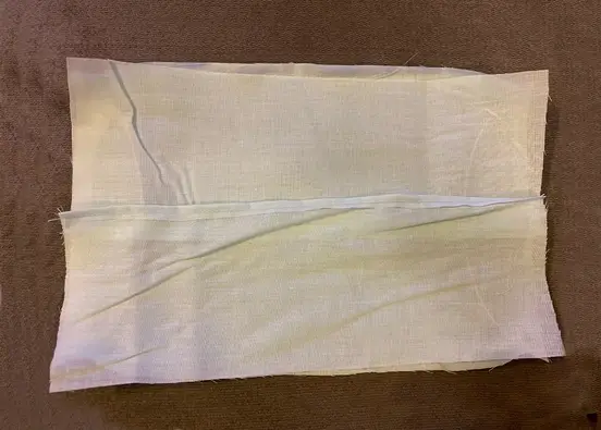 A folded piece of cotton woven fabric.