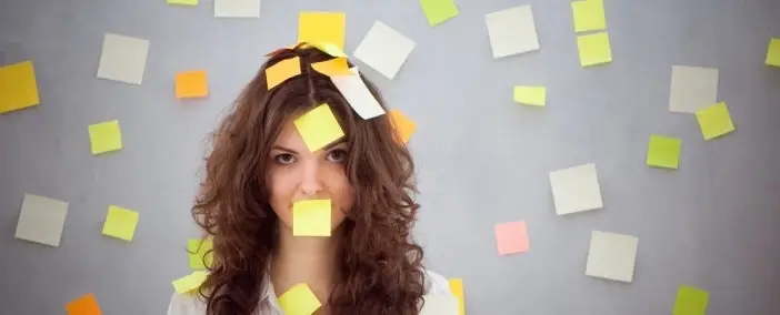A woman covered in Post-its.