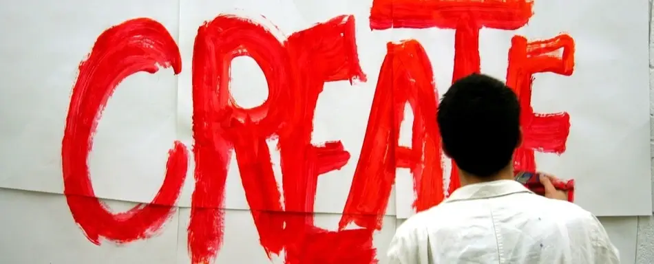 A person painting the word 'Create'.
