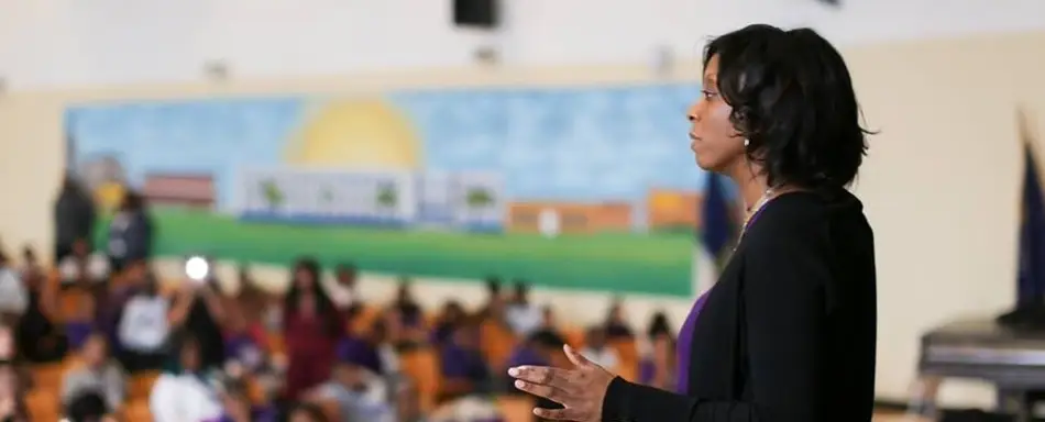 A Black woman leads a classroom.