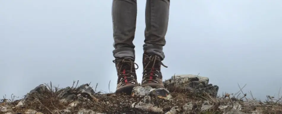 Someone standing on a pile of rocks.