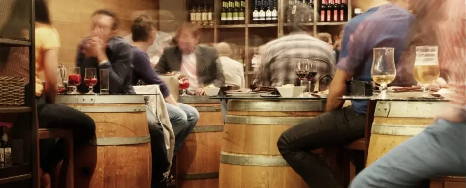 A crowd of people at a bar.