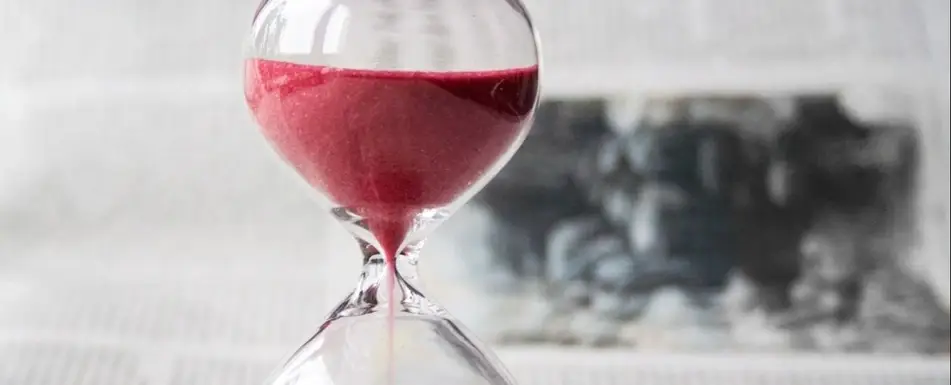 An hourglass with red sand.