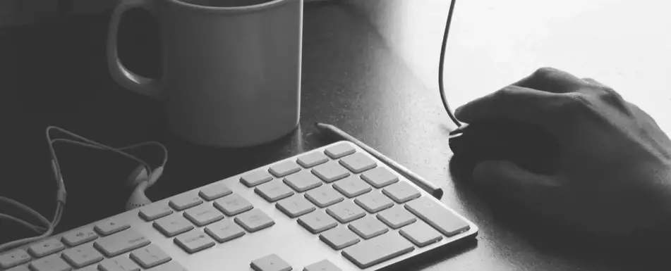 A mouse next to a keyboard.