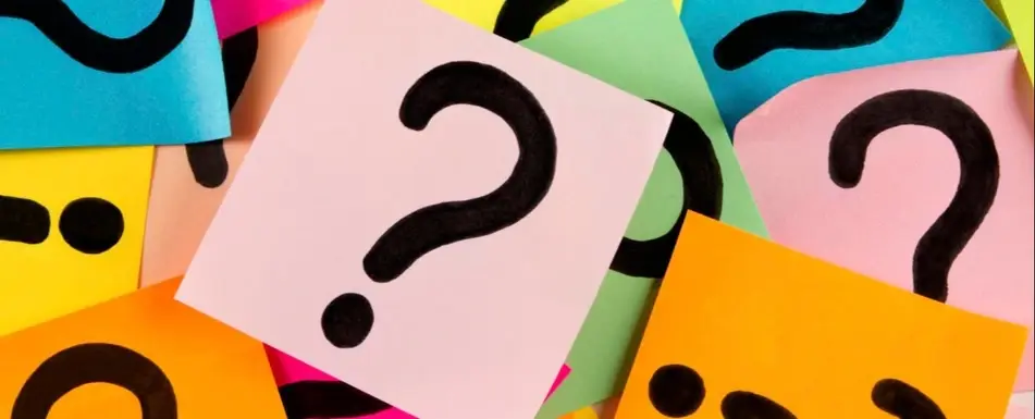 Different colored post its with question marks on them.