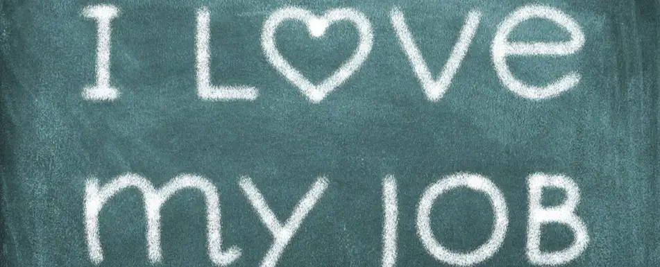 "I love my job," written on a chalk board.
