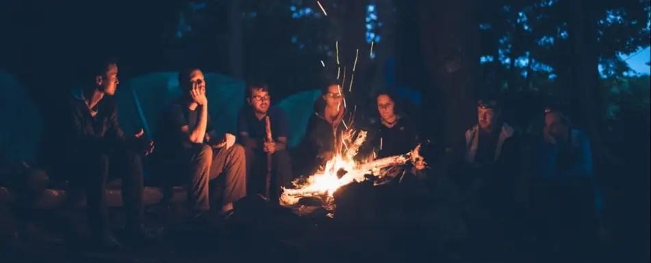 A group of people around a bonfire.
