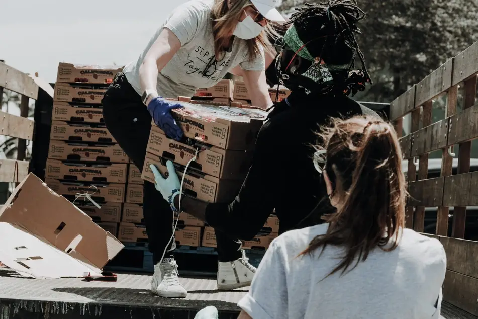 food bank volunteers loading food off of a truck