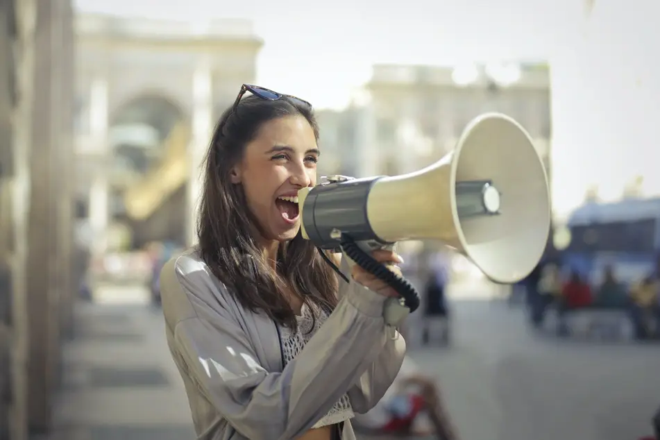 woman with megaphone smiling