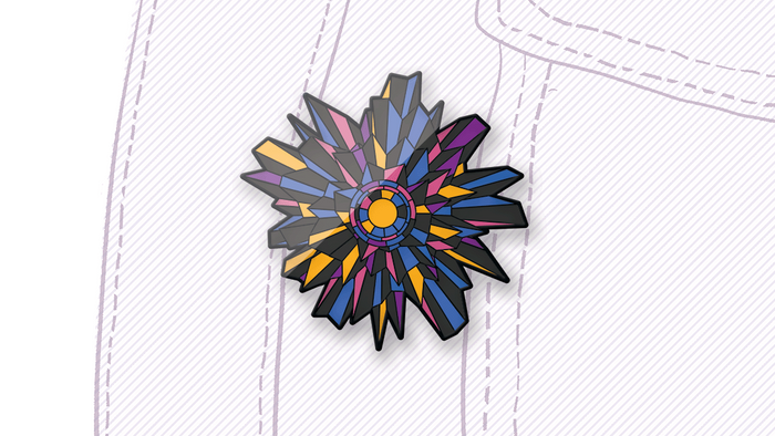A shiny enamel pin looking like a spikey flower in yellow, blue, black and pink