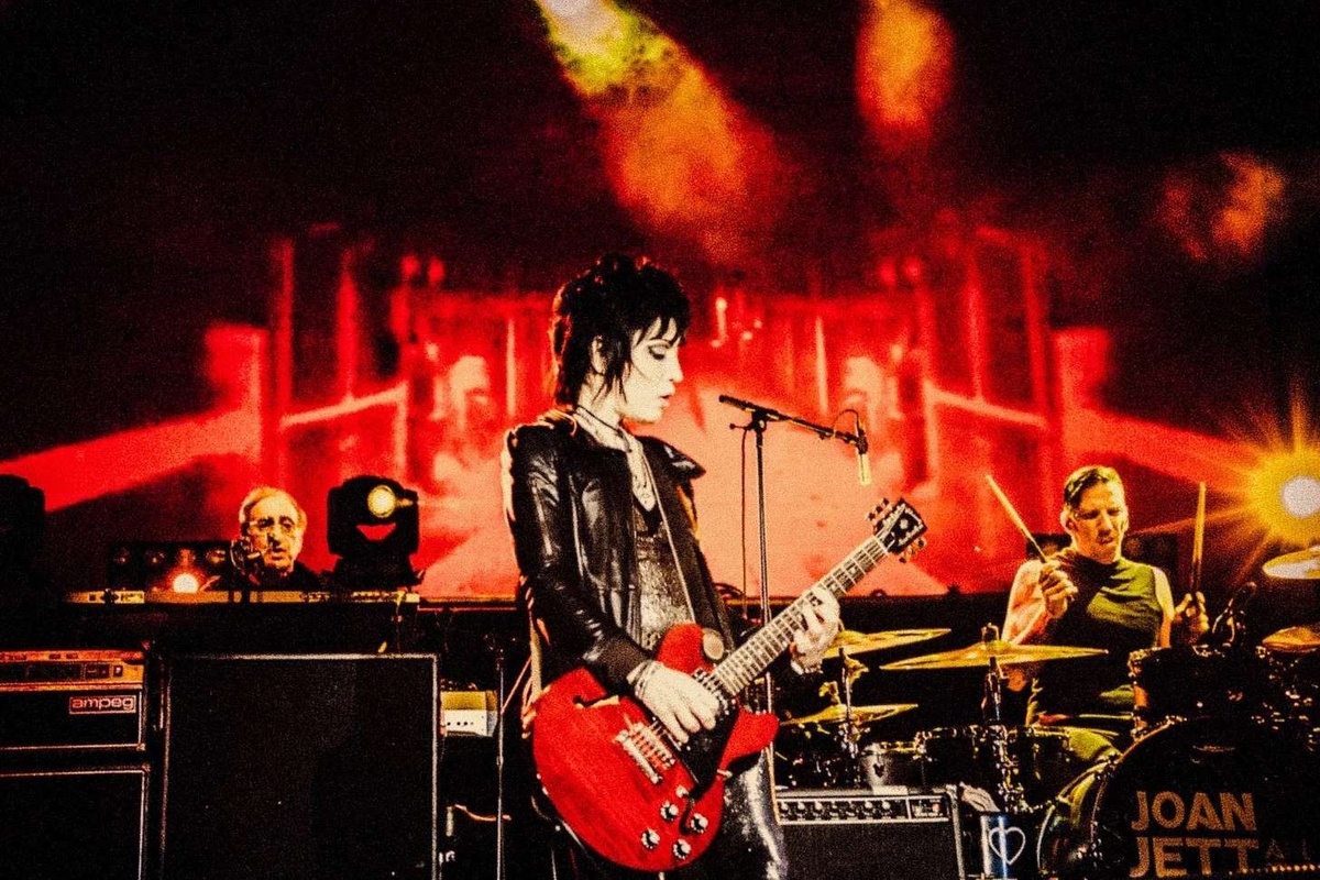Joan Jett performing with a red guitar