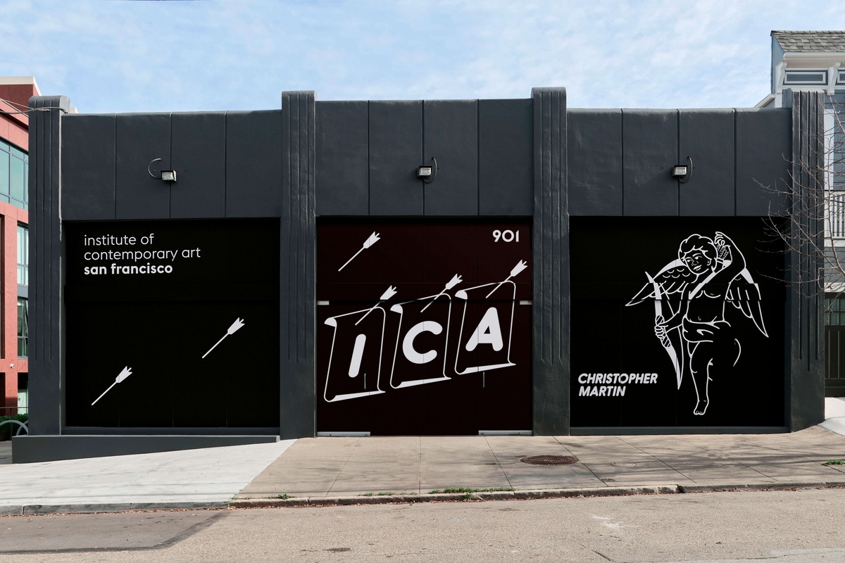 Dark gray building with black vinyl with white text of ICA SF and a cherub shooting an arrow