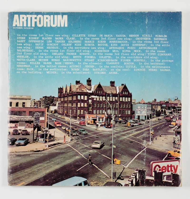 A vintage magazine cover with a color image of the MoMA PS1 building in the center. A gradient blue to white sky dominates the top half of the cover, overlayed with the title "Artforum" and a paragraph of text. The bottom half of the cover foregrounds an intersecting road outside of PS1.
