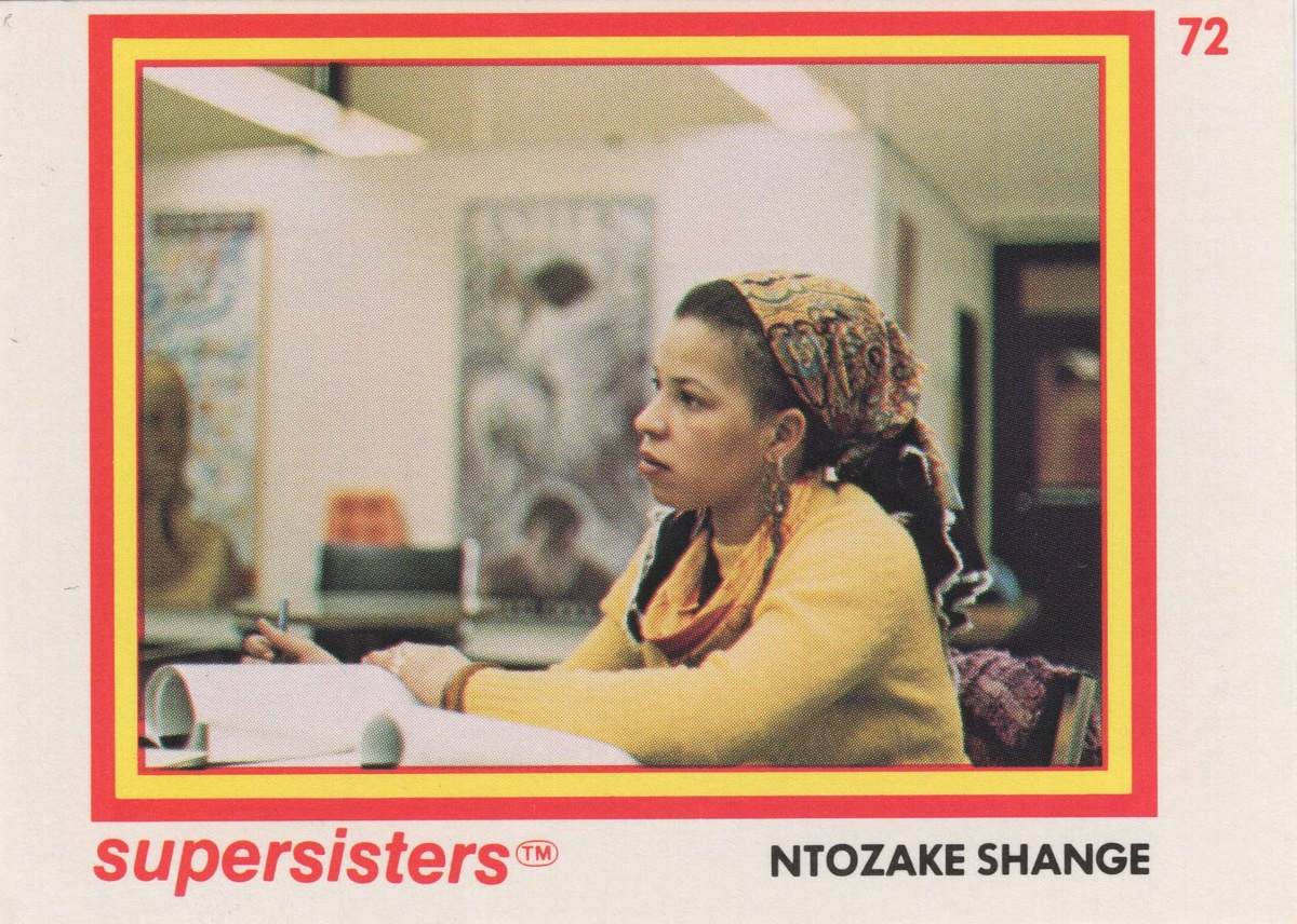 Ntozake Shange supersisters™ card. She is a young black woman wearing a yellow sweater and patterned scarf. She is sitting in a classroom taking notes.