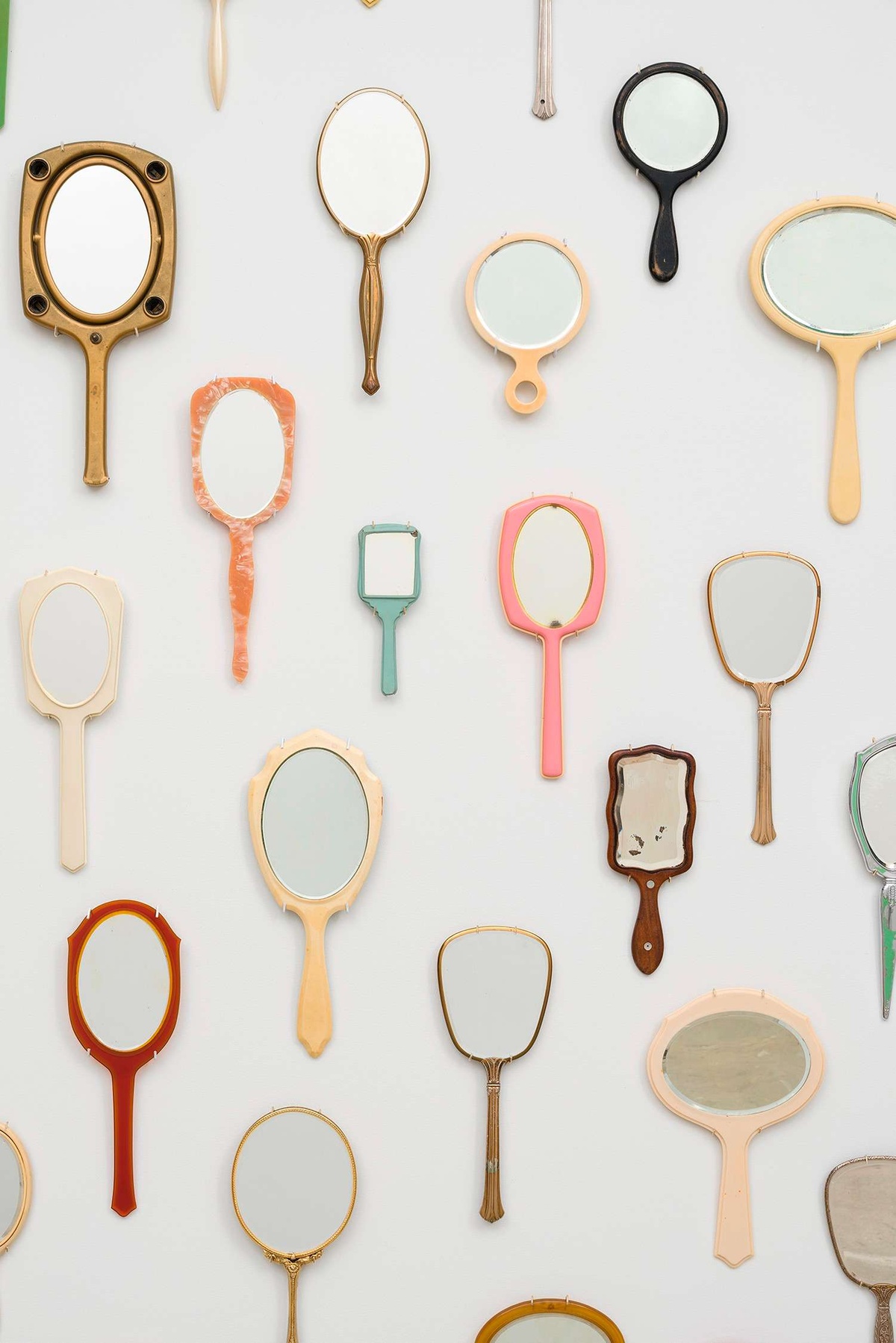 various assortment of Handheld mirrors installed on a wall