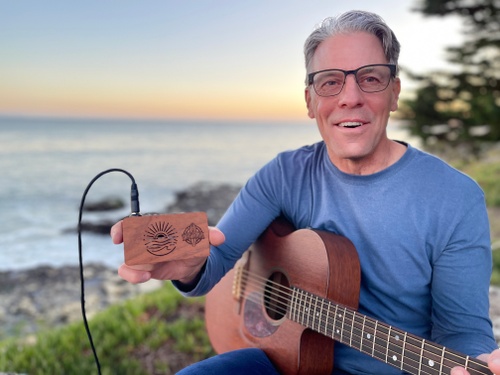 Guitarist Daniel Vanek with the Ventana Pocket Wave Amp during a jam session on the beach in Santa Cruz, California