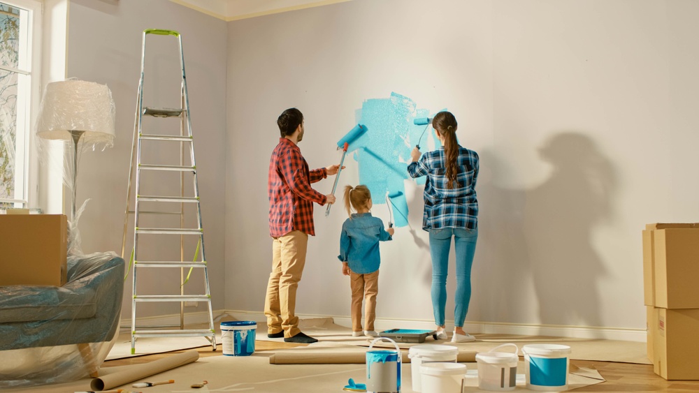 family moving into first home and painting walls