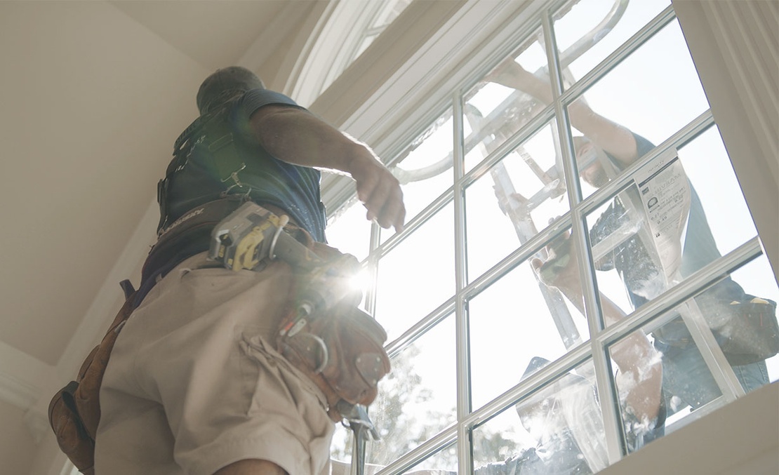 Window installers replacing window in customers home