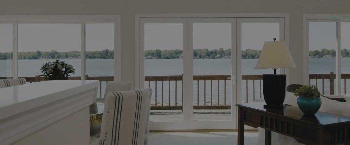 Infinity windows and doors in a living room overlooking a lake