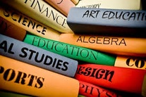 Black and White photo of students sitting at desks with pen and paper