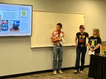 three people presenting information to school board