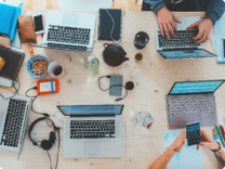 Clutter table with multiple laptops