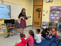 Music teacher Ms. Macedonio playing Ukulele 