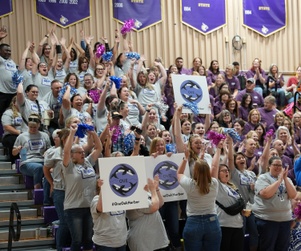 Olympic View Elementary staff cheering with signs