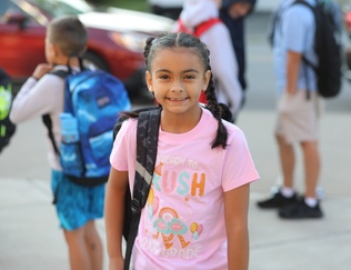 A student arrives on the first day of school