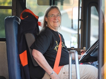 A bus driver smiles on the first day of school