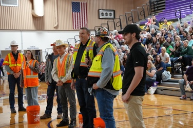 Construction crews help toss out t-shirts to staff