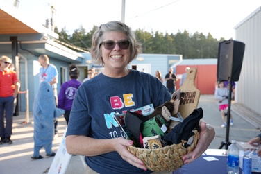 staff member holds a raffle basket